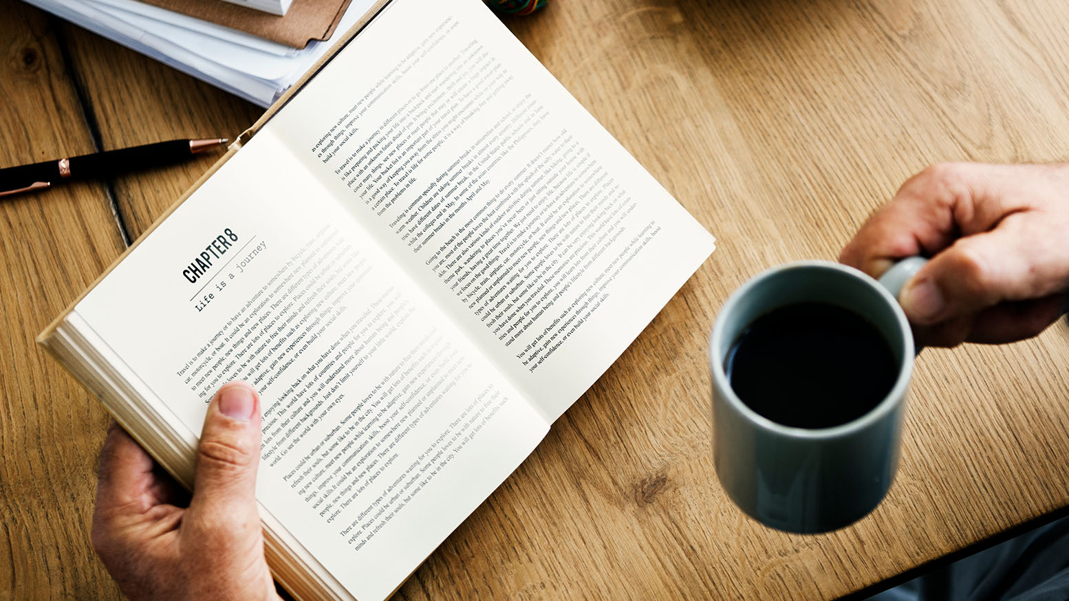 Set up a coffee shop Person reading a book while drinking coffee